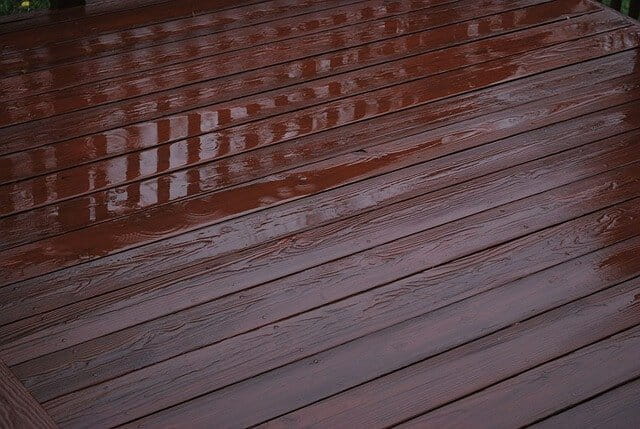 Wasserschäden auf Parkett-, Dielen- oder Laminatböden sollten umgehend entfernt und gegebenenfalls umfassend saniert werden. Das Symbolfoto zeigt einen Dielenboden mit stehenden Wasser. 